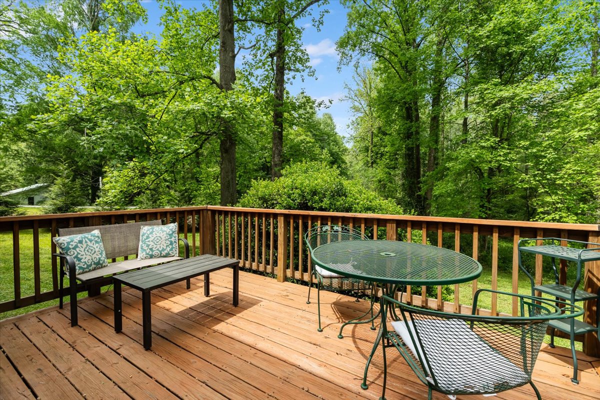Back deck with seating and wooded view